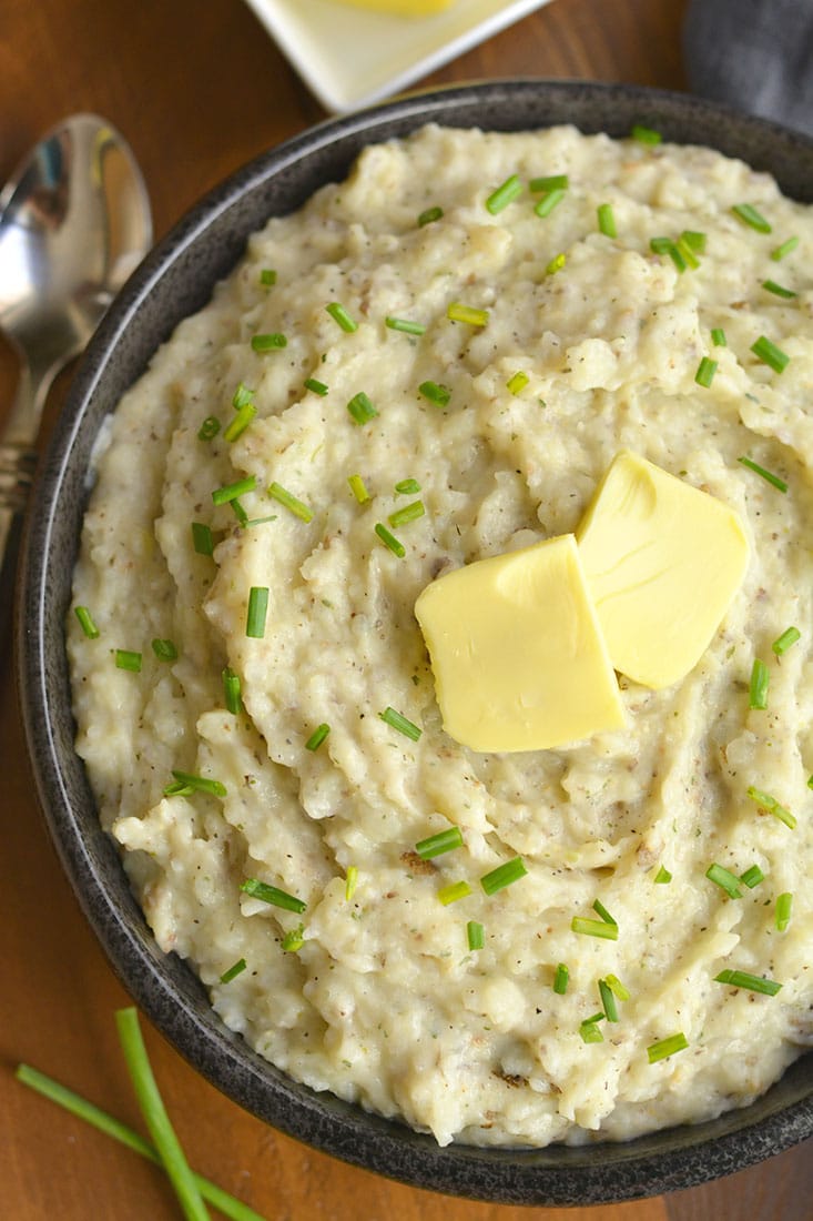 Healthier Mashed Potatoes & Cauliflower! This lighter version of the traditional dish adds cauliflower & Greek yogurt that no one will notice. A healthier side for your dinner table! Gluten Free + Low Calorie