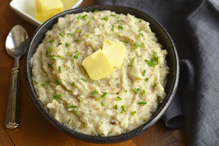 Healthier Mashed Potatoes & Cauliflower! This lighter version of the traditional dish adds cauliflower & Greek yogurt that no one will notice. A healthier side for your dinner table! Gluten Free + Low Calorie