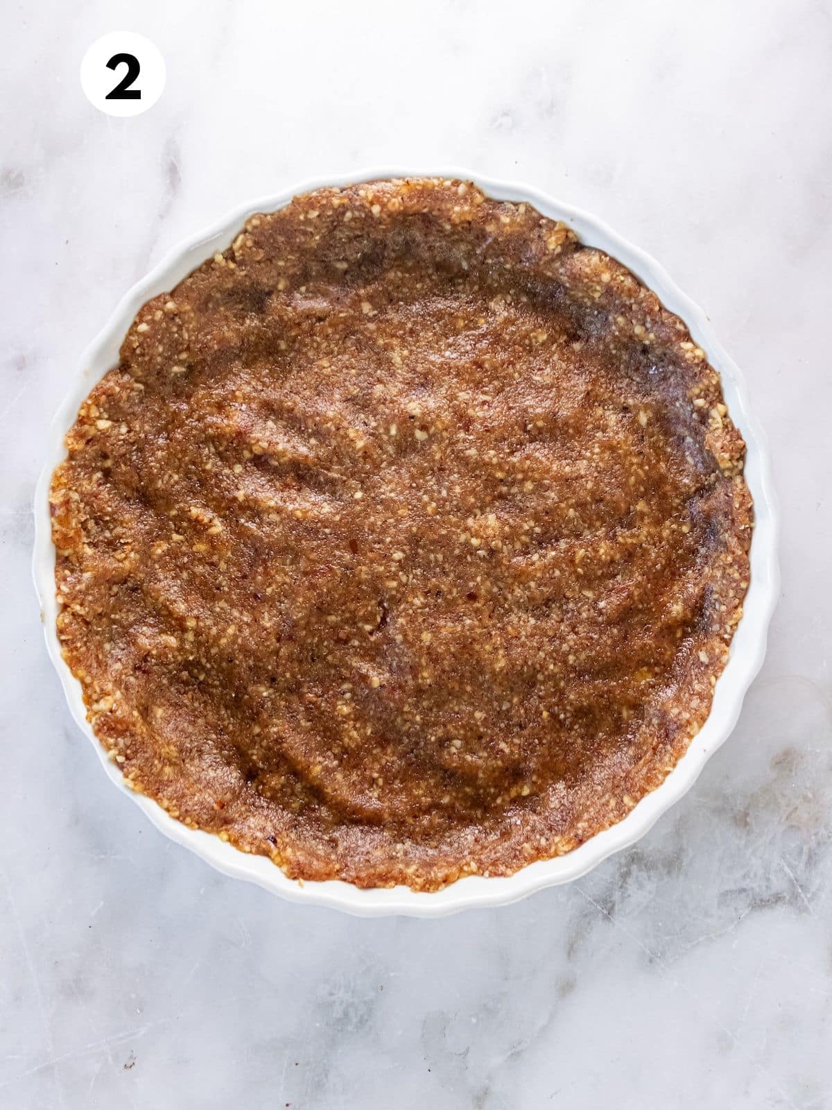 Unbaked pumpkin pie crust in a pan.