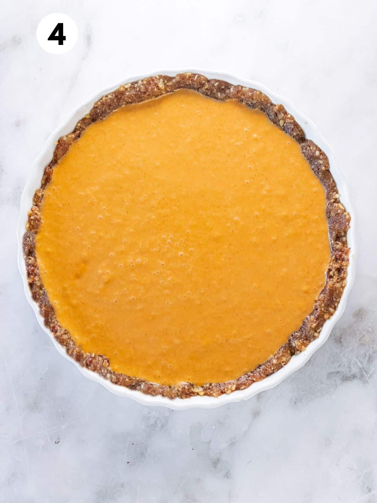 Unbaked pumpkin pie in a pie pan.