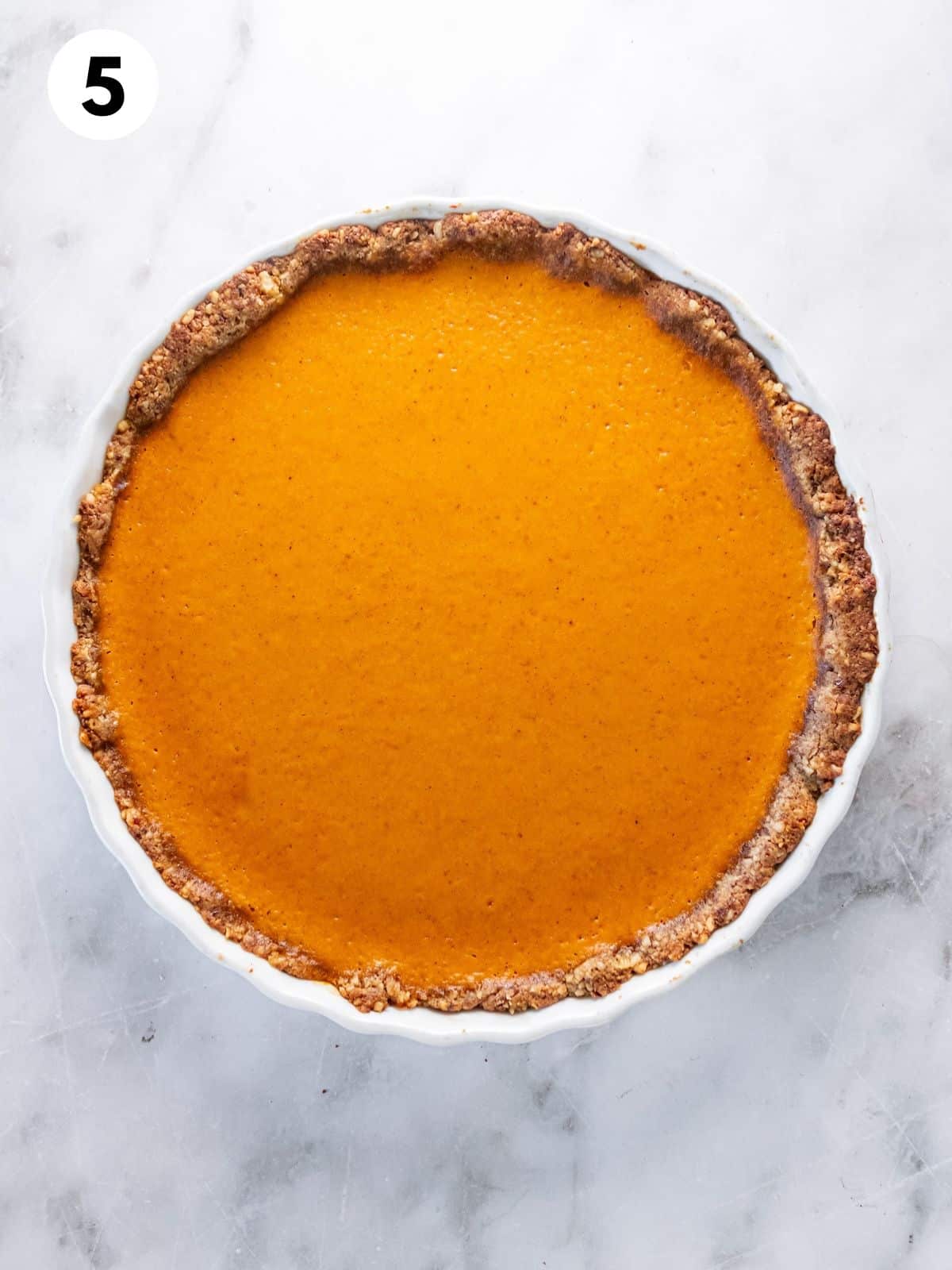 Baked low calorie pumpkin pie in a pie pan.
