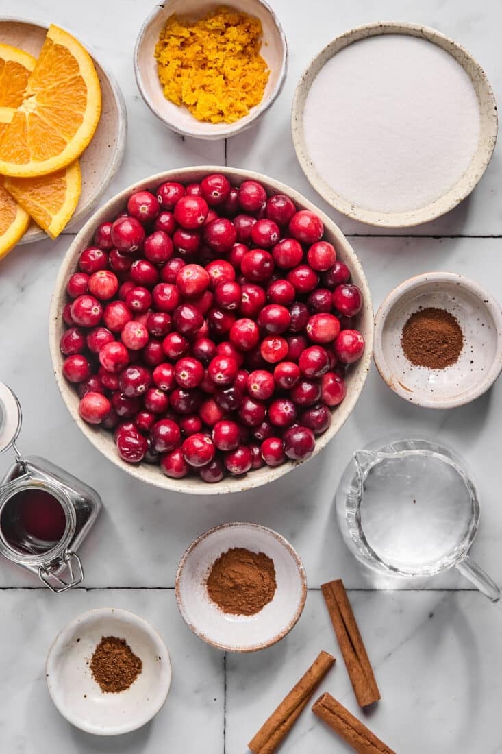 Ingredients to make healthy cranberry sauce on the table before preparing.