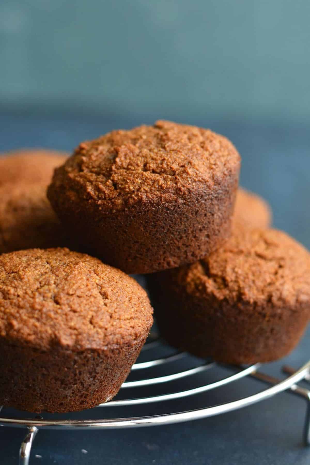 Healthy gingerbread muffins on a metal cooling rack.
