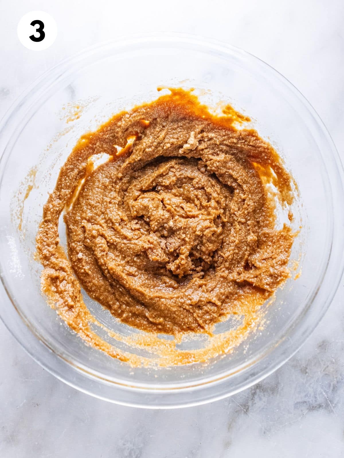 Gingerbread muffin batter mixed in a bowl.