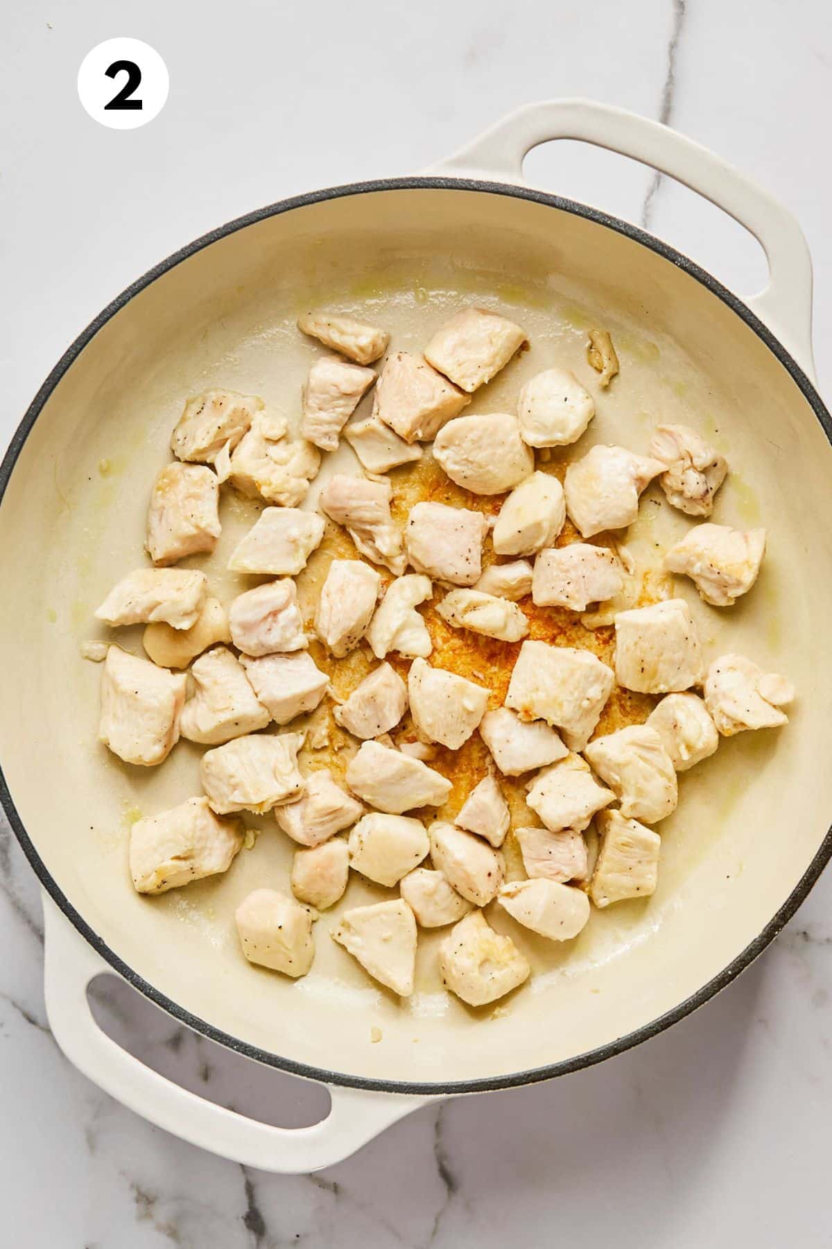 Cooked chicken in a skillet.
