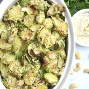 Crispy Brussels Sprouts With Cashew Cream Sauce! Roasted Brussels sprouts tossed in a Vegan creamy cashew sauce. A healthy spin on Brussels sprouts gratin that's dairy-free and delicious. A healthy side dish to add to any meal. Vegan + Paleo + Gluten Free + Low Calorie + Whole30