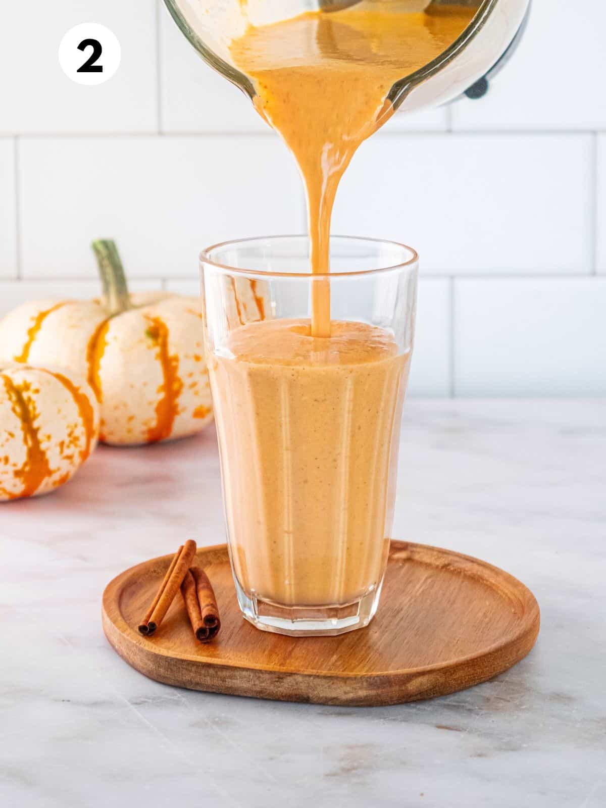 Gingerbread smoothie being poured into a glass.