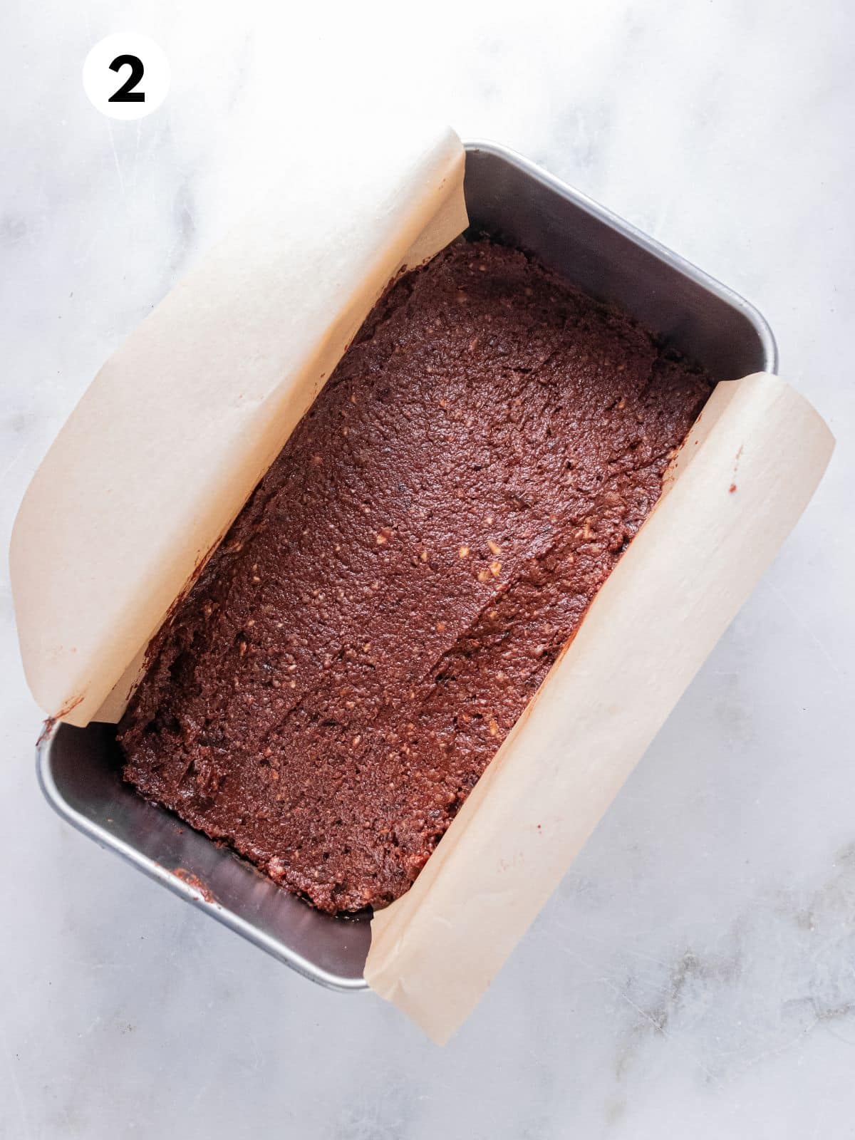 Brownie batter poured into a pan.