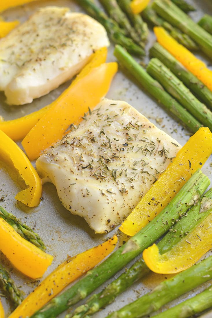 Sheet Pan Cod with Veggies! Baked cod with garlic & herbs with roasted veggies. A light, easy, Paleo meal that takes less than 30 minutes to make & prep. Baked cod never was so easy or so good! Gluten Free + Low Calorie + Paleo + Whole30