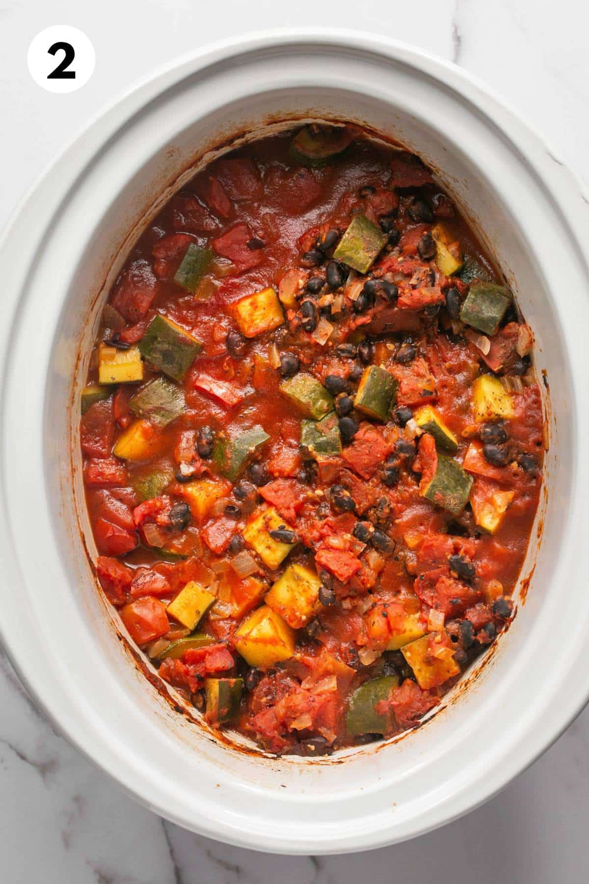 Black bean chili cooked in a slow cooker.