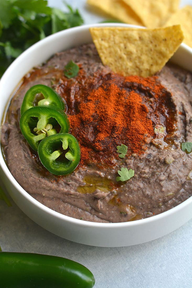 Spicy Black Bean Hummus Without Tahini lightened up by omitting the traditional ingredient without sacrificing taste. Pair with veggies & crackers for a healthy snack or spread on sandwich for extra protein & spice! Gluten Free + Vegan + Low Calorie