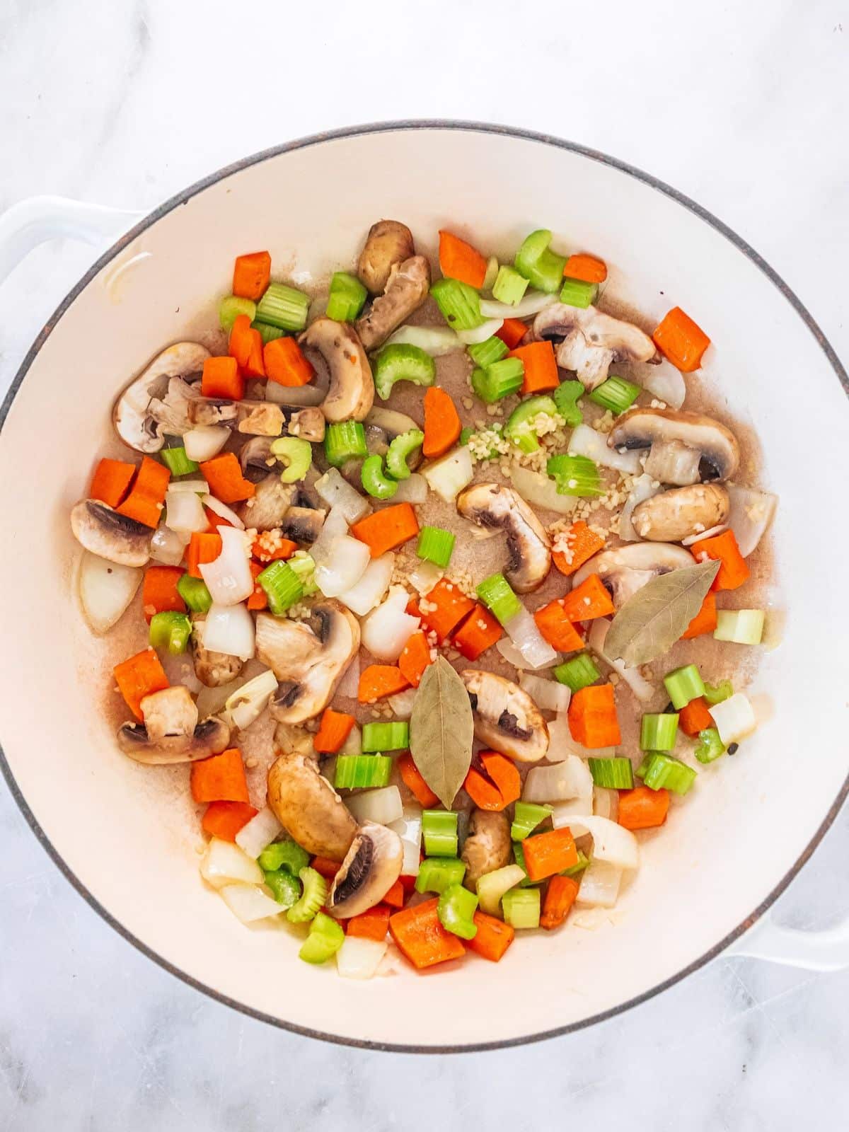 Chopped vegetables being cooked in a pot.