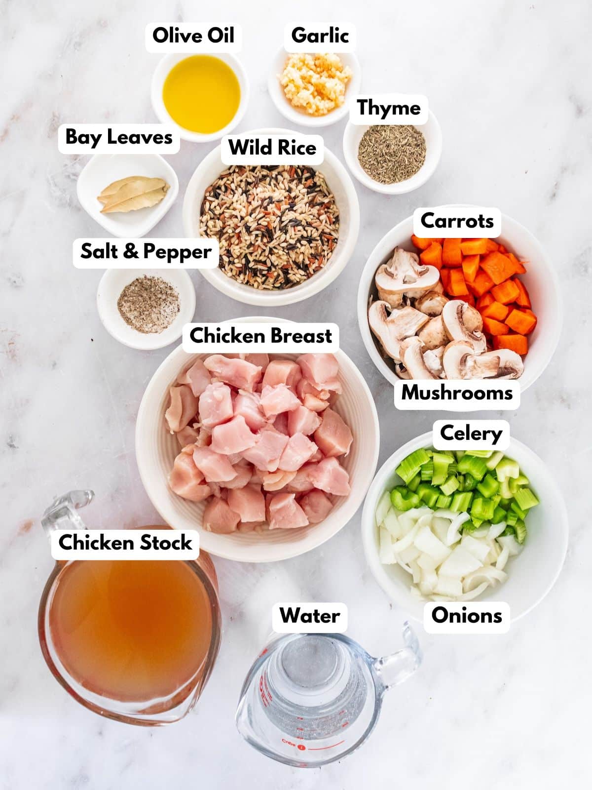 Ingredients to make chicken wild rice soup in bowls.