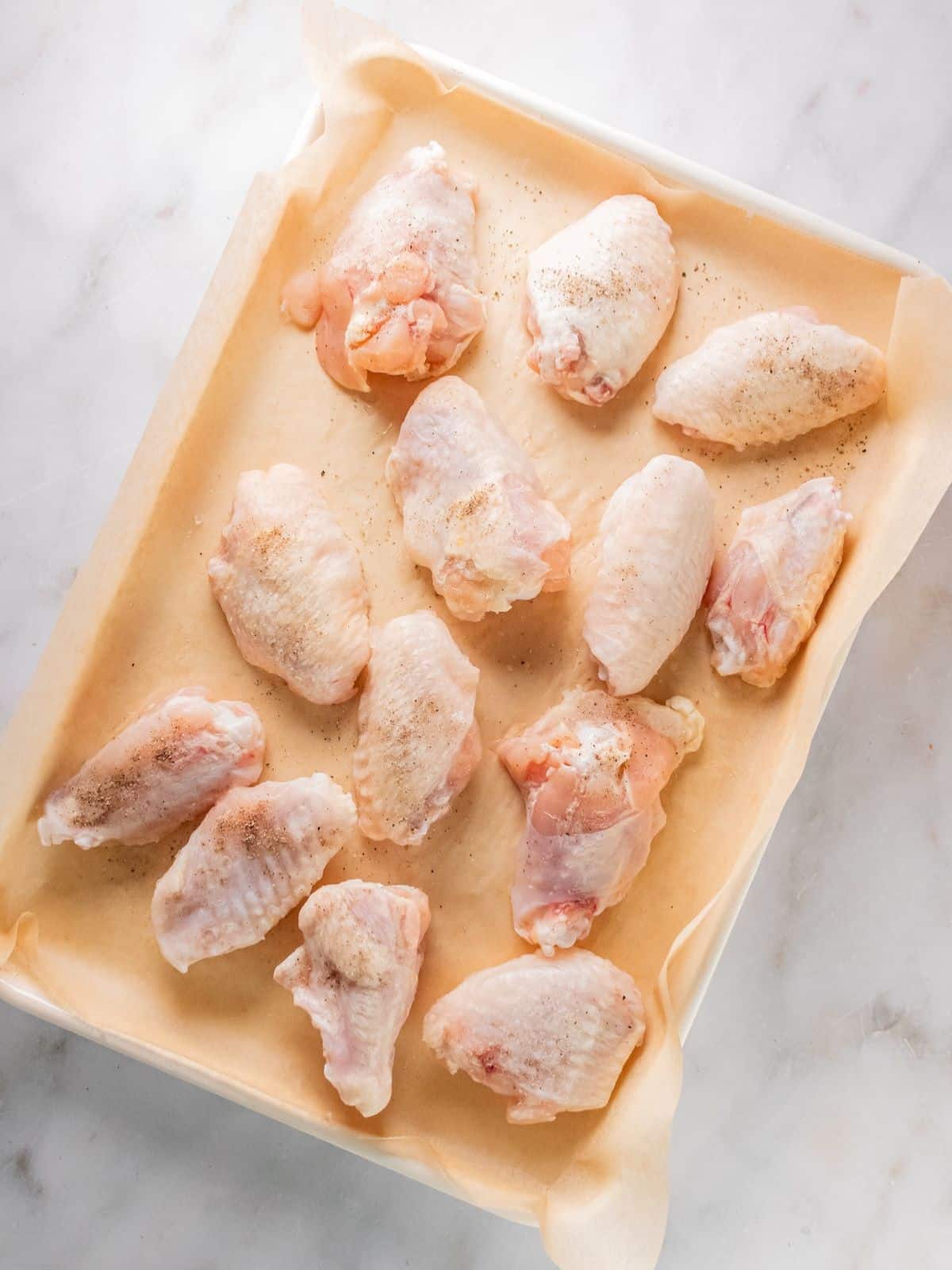 Raw chicken wings seasoned.