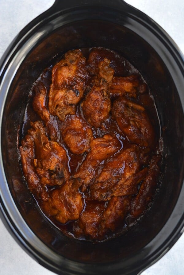 Healthy Crockpot BBQ Wings! All the spicy flavor you love in chicken wings packed in a healthy, low sugar BBQ sauce. The perfect game day appetizer, party favor, or dinner for healthy eaters! Gluten Free + Paleo + Low Calorie