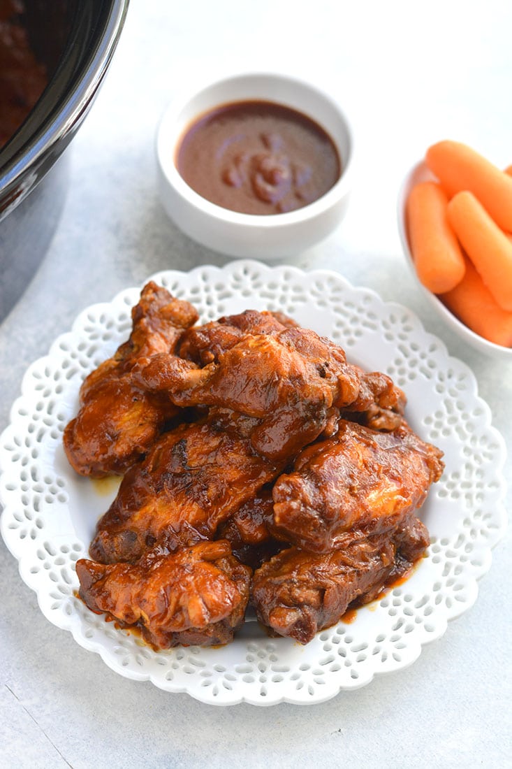 Healthy Crockpot BBQ Wings! All the spicy flavor you love in chicken wings packed in a healthy, low sugar BBQ sauce. The perfect game day appetizer, party favor, or dinner for healthy eaters! Gluten Free + Paleo + Low Calorie