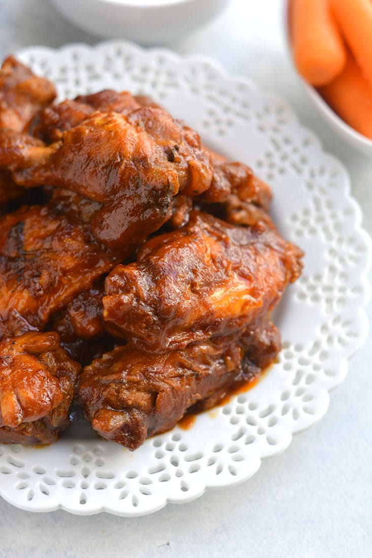 Healthy Crockpot BBQ Wings! All the spicy flavor you love in chicken wings packed in a healthy, low sugar BBQ sauce. The perfect game day appetizer, party favor, or dinner for healthy eaters! Gluten Free + Paleo + Low Calorie