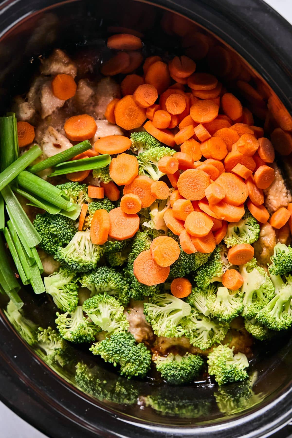 Chopped vegetables added to the slow cooker.