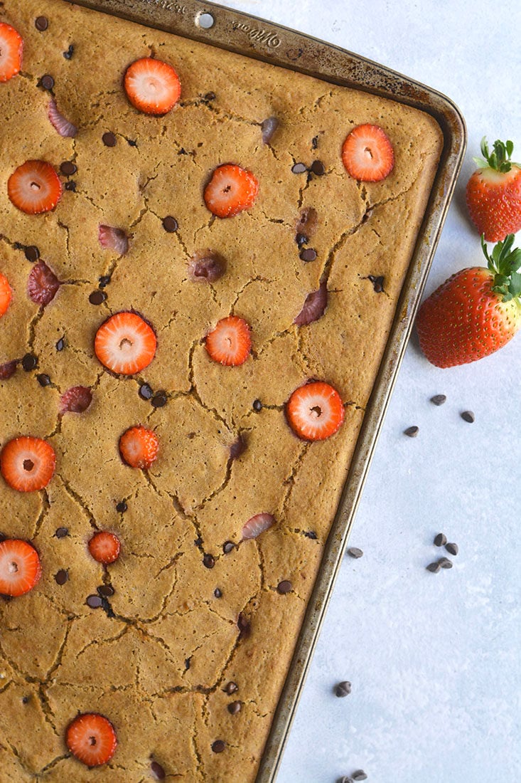 Strawberry Sheet Pan Pancakes! An easy way to make pancakes in the oven! Just blend the ingredients, pour, bake and slice. An easy way to meal prep a healthy breakfast for the week. This recipe allows you to make all your pancakes at one time without the mess. Gluten Free + Low Calorie 
