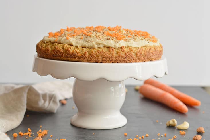 Paleo Almond Flour Carrot Cake! This carrot cake recipe is healthy super simple & quick to make. Topped with a cashew maple frosting that's irresistible. Soft, moist & dairy-free. Vegan option included! Paleo + Vegan