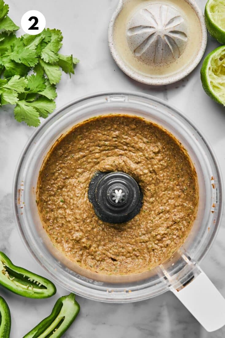 Black bean dip after blending in a food processor bowl.