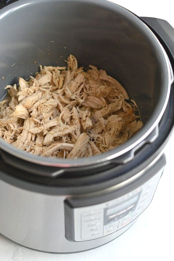 Instant Pot Shredded Chicken! Meal prep chicken in 20 minutes in an Instant Pot with only a few ingredients. Perfect for easy low carb lunches or weeknight dinners. Serve on a salad, over rice, in tacos, casseroles and more! Low Carb, Low Calorie, Paleo, Gluten Free