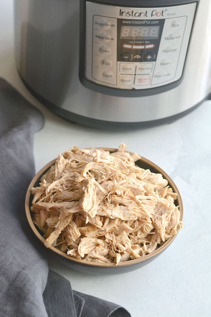 Instant Pot Shredded Chicken! Meal prep chicken in 20 minutes in an Instant Pot with only a few ingredients. Perfect for easy low carb lunches or weeknight dinners. Serve on a salad, over rice, in tacos, casseroles and more! Low Carb, Low Calorie, Paleo, Gluten Free