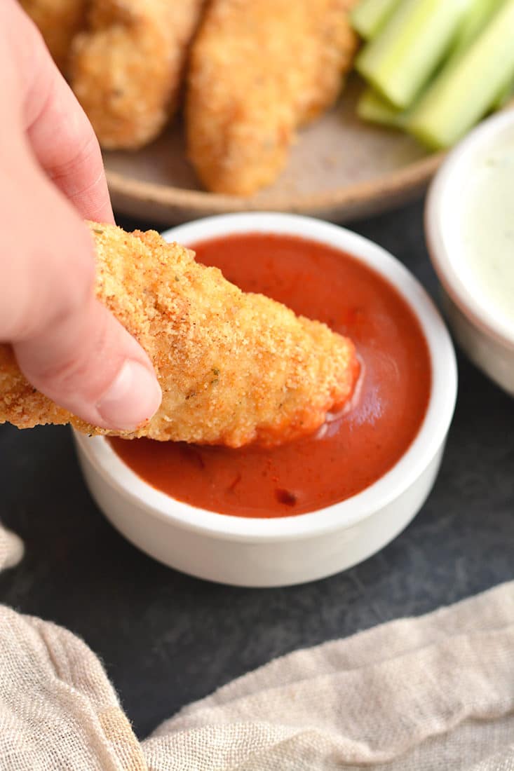 Almond Flour Buffalo Chicken Tenders! These better for you chicken tenders are made with healthy fat and protein from almond flour instead of traditional breadcrumbs that are higher in carbohydrates. This lighter meal is quick to make in under 30 minutes and healthier. Paleo + Gluten Free + Low Calorie