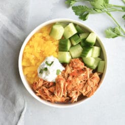 Instant Pot Harissa Shredded Chicken Bowls! This simple, healthy shredded chicken is cooked in under 30 minutes in an Instant Pot with Harissa for a spicy kick! Paired with sliced cucumber, bell pepper and Greek yogurt for a complete meal! Low Calorie + Gluten Free