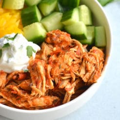 Instant Pot Harissa Shredded Chicken Bowls! This simple, healthy shredded chicken is cooked in under 30 minutes in an Instant Pot with Harissa for a spicy kick! Paired with sliced cucumber, bell pepper and Greek yogurt for a complete meal! Low Calorie + Gluten Free