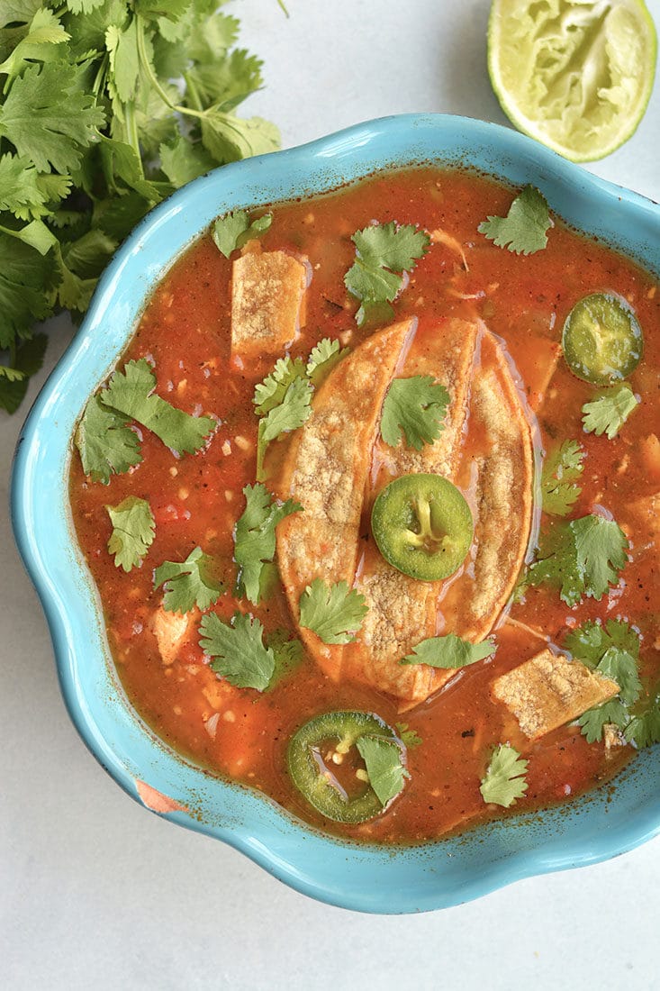 Meal Prep Chicken Tortilla Soup! A gluten free and Paleo soup that's nourishing and slightly spicy! Roasted then blended pasilla chilies and carrots give this soup amazing flavors. Made in 30 minutes in an Instant Pot with a stovetop option! Paleo + Low Calorie + Gluten Free