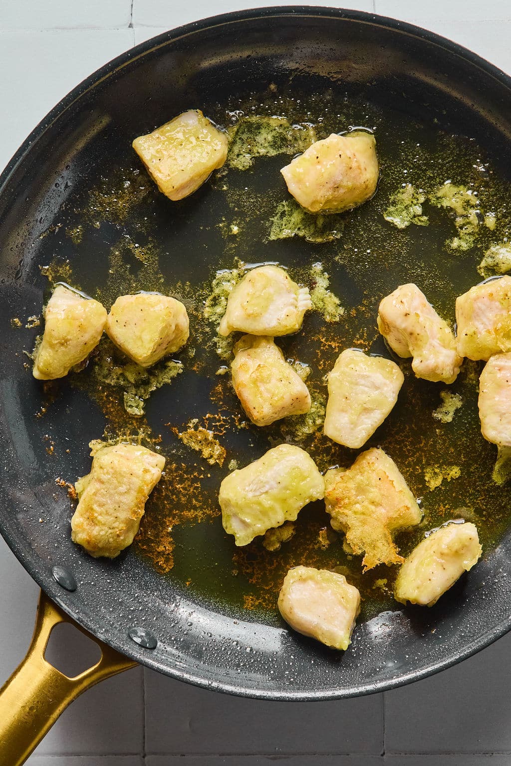 Chicken cooking in a pan.