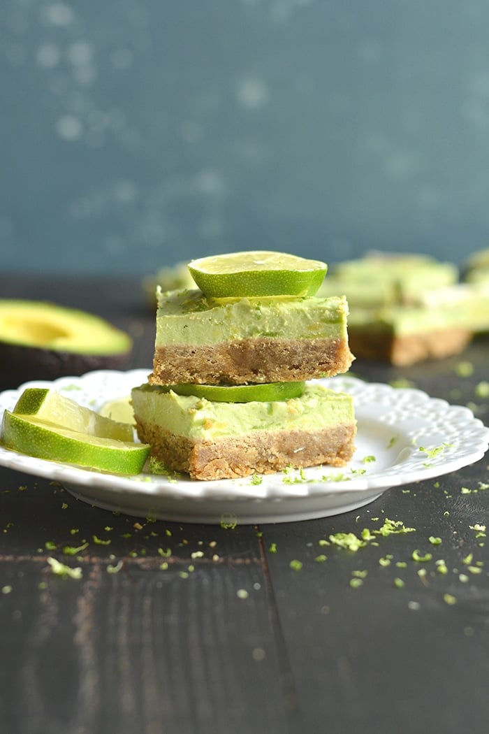 Avocado Key Lime Pie Bars! Made with a buttery gluten free oat crust that tastes like graham crackers and topped with creamy lime avocado Greek yogurt filling for an irresistible treat! A lighter twist on Key Lime Pie that's made with healthier ingredients and balanced in nutrition. Gluten Free + Low Calorie