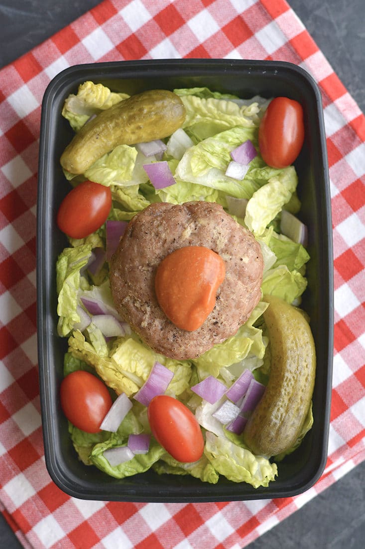 Meal Prep Turkey Burger Salad! Stuffed with parmesan and garlic then baked on a sheet pan. These burgers make the most flavorful, delicious burgers. Simple to make, gluten free and low carb! Paired with a salad and ketchup mustard dressing for a quick and easy meal prep! Gluten Free + Low Calorie + Low Carb