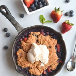 Low Sugar Berry Cobbler is the ultimate summertime treat! Made in one skillet with glycemic friendly ingredients. Low in calories and higher in protein than traditional cobblers, this warm weather dessert is sure to be your new favorite treat. Paleo + Gluten Free Options