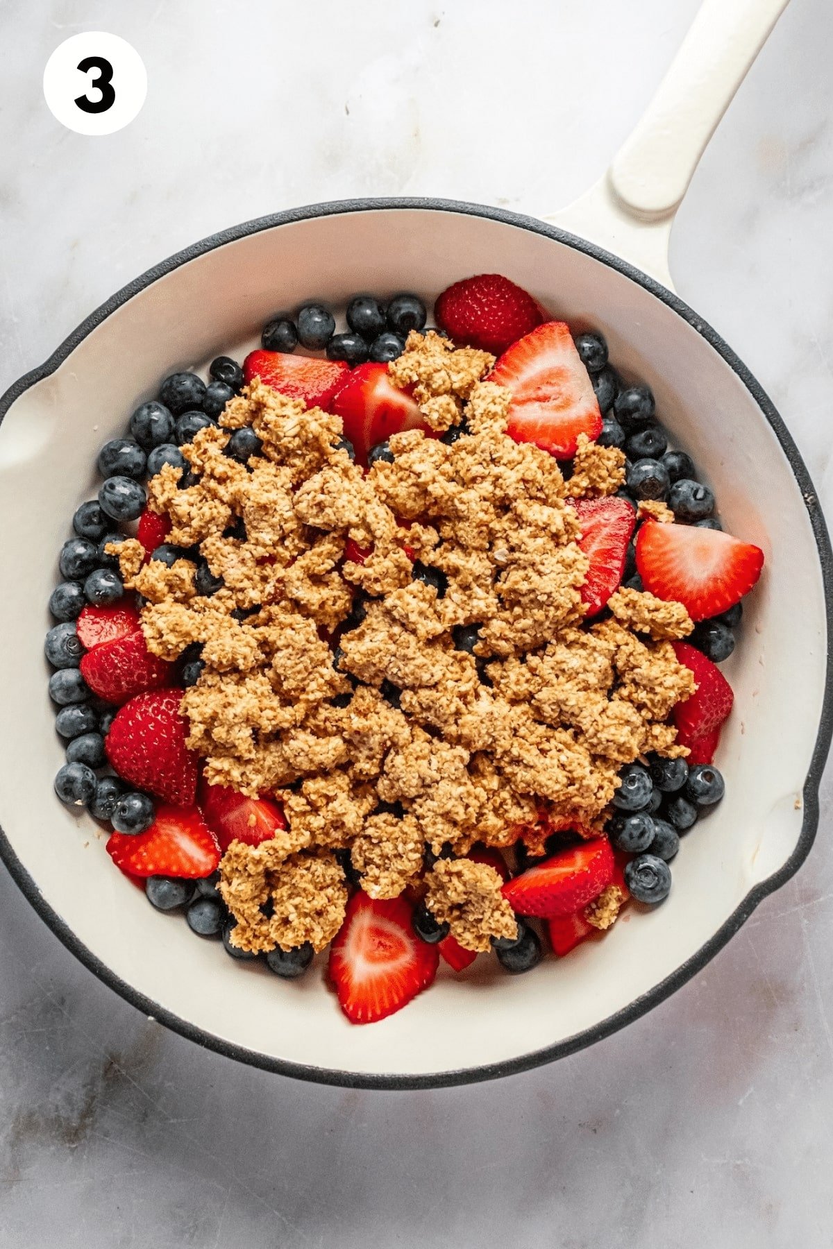 Cobbler dough spooned over the top of the berries. 