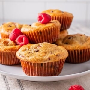 raspberry muffins on a white plate.