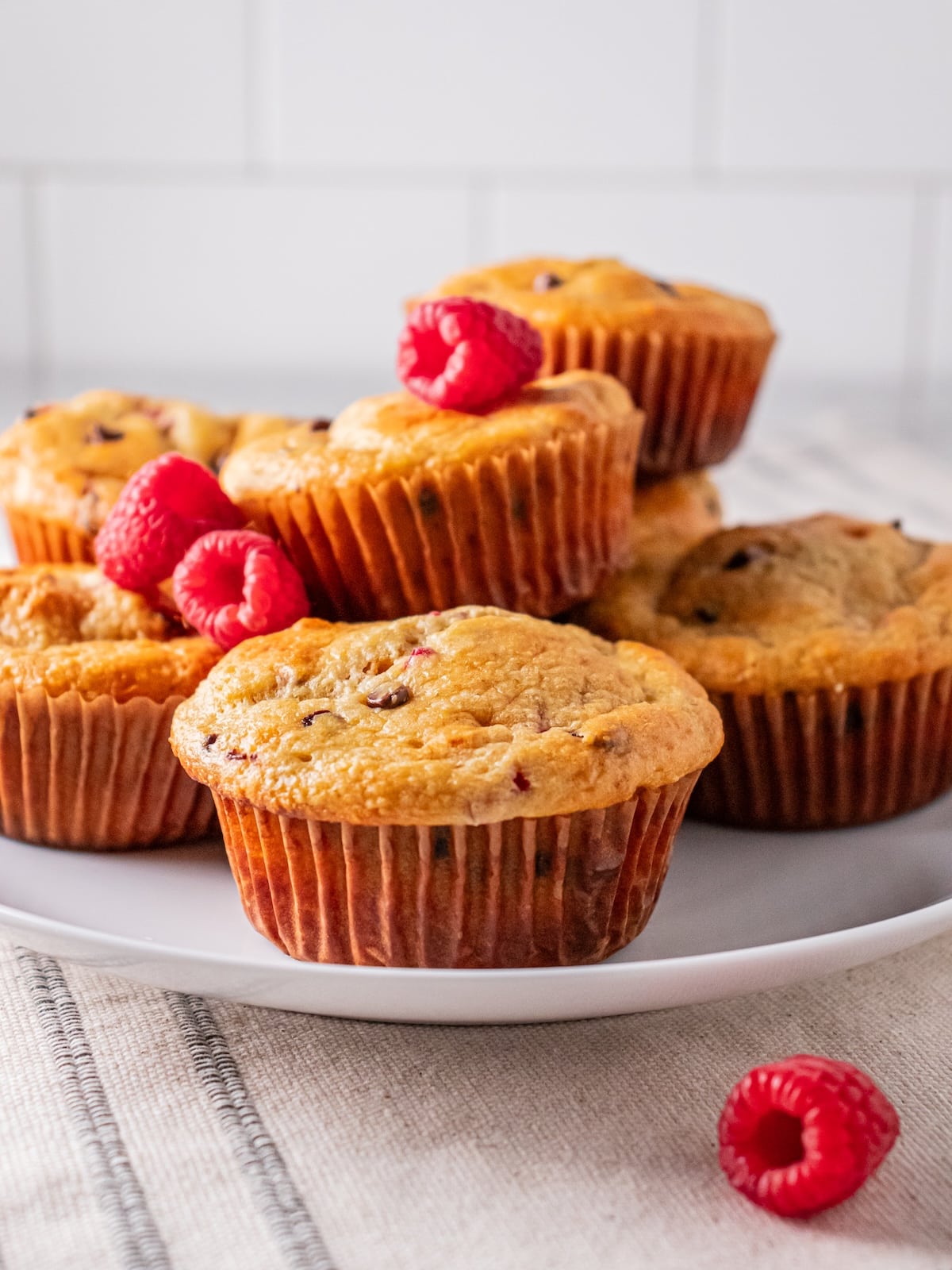 raspberry muffins on a white plate.