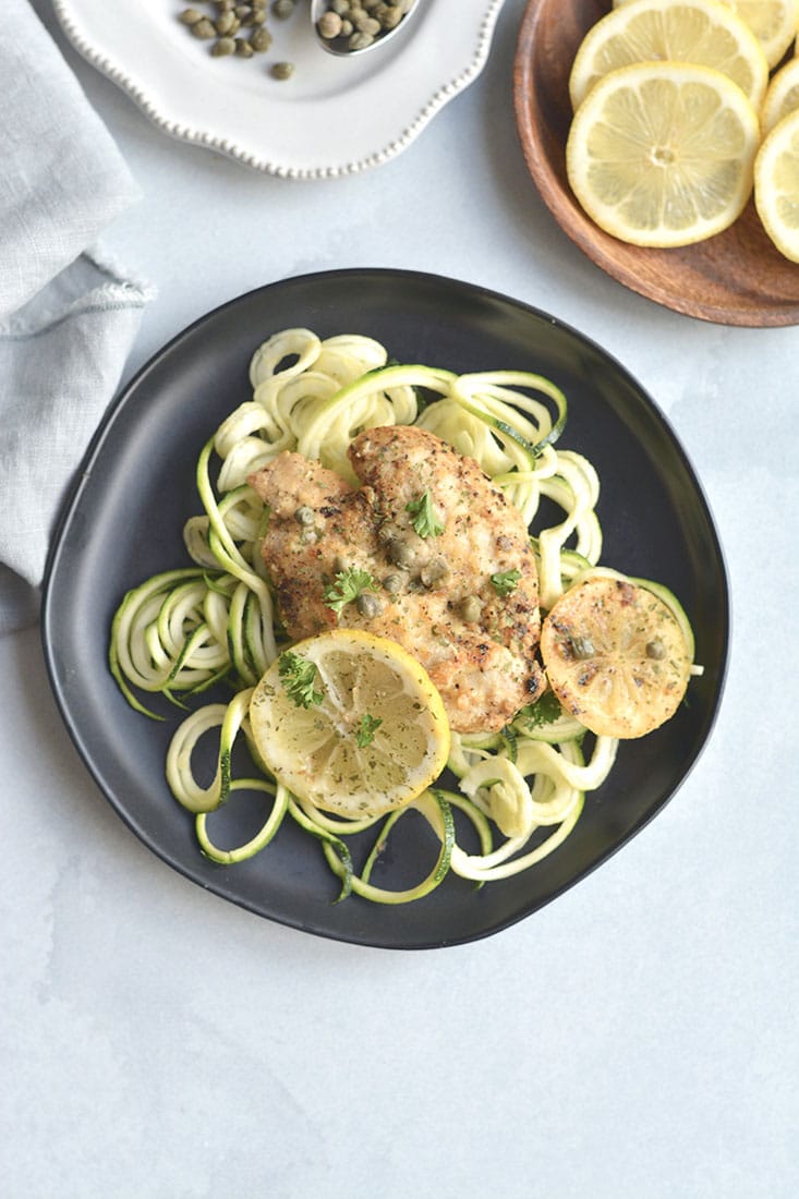 Lemon Chicken Piccata Zucchini Noodles! An easy, one skillet meal that adds tons of flavor to chicken. Served over zucchini noodles for a lighter, low carb twist on lemon piccata. All the flavor without all the calories! Paleo + Low Calorie + Low Carb + Gluten Free 