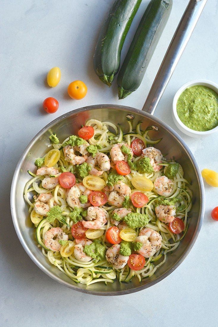 Shrimp Pesto Zucchini Noodles! Traditional spaghetti is replaced with low carb zucchini noodles. A lighter and healthier spin on spaghetti paired with skillet baked shrimp and homemade spinach walnut pesto. High in protein and healthy fat, this easy 30-minute meal is perfect for a quick lunch or dinner. Low Carb + Paleo + Gluten Free + Low Calorie