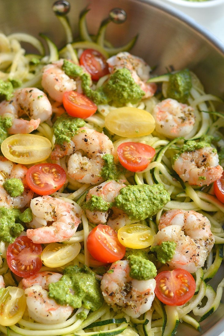 Shrimp Pesto Zucchini Noodles! Traditional spaghetti is replaced with low carb zucchini noodles. A lighter and healthier spin on spaghetti paired with skillet baked shrimp and homemade spinach walnut pesto. High in protein and healthy fat, this easy 30-minute meal is perfect for a quick lunch or dinner. Low Carb + Paleo + Gluten Free + Low Calorie