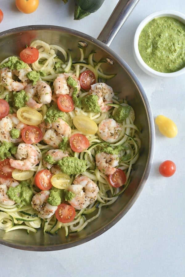 Shrimp Pesto Zucchini Noodles! Traditional spaghetti is replaced with low carb zucchini noodles. A lighter and healthier spin on spaghetti paired with skillet baked shrimp and homemade spinach walnut pesto. High in protein and healthy fat, this easy 30-minute meal is perfect for a quick lunch or dinner. Low Carb + Paleo + Gluten Free + Low Calorie