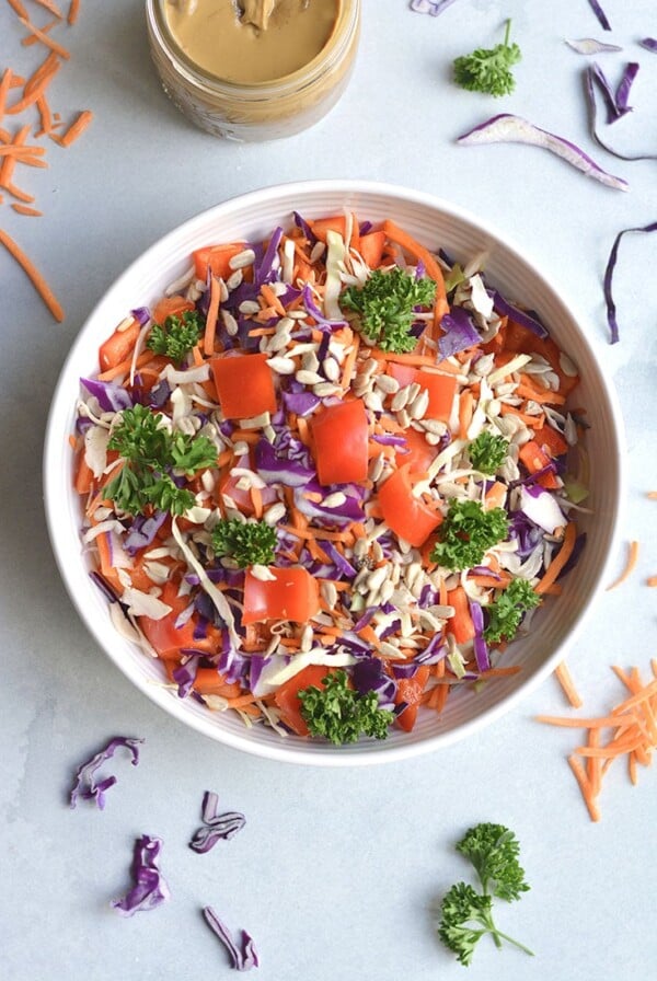 Thai Asian Salad with nut free sunflower dressing! A loaded detox salad with cabbage, carrots, and bell peppers tossed in a spicy Asian dressing. Healthy fat and carbs unite! Serve as a side salad or add your favorite lean protein for a complete meal. Vegan + Paleo + Low Calorie + Gluten Free