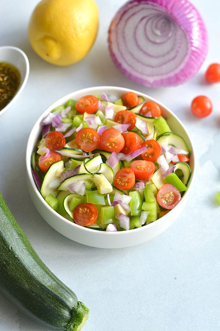 Paleo Zucchini Pasta Salad! Replace pasta with spiralized zucchini for a light, refreshing and filling pasta salad! A low carb pasta salad filled with vegetables. Pair with your favorite lean protein for a complete meal. Low Carb + Gluten Free + Paleo + Low Calorie + Vegan