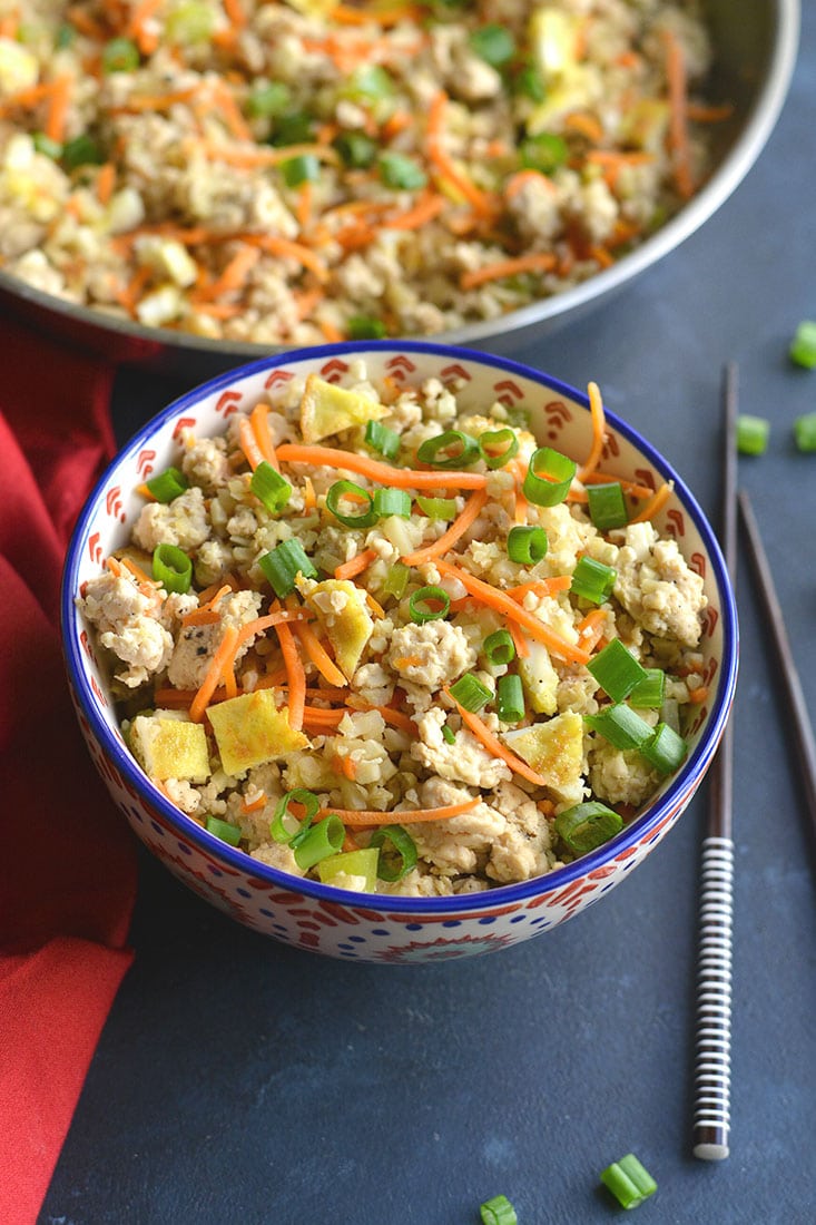 Meal Prep Chicken Cauliflower Fried Rice! Cauliflower rice replaces the grains in this low carb dish. Naturally gluten free, a good source of veggies and incredibly delicious! Low Carb + Paleo + Gluten Free