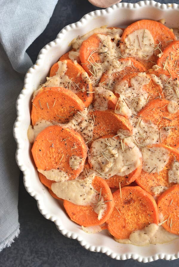 Whole30 Sweet Potato Au Gratin are sweet potatoes drizzled in a dairy-free cashew "cream" sauce. This Vegan and Paleo dish makes an easy side dish to a family dinner or a delicious to your holiday table.