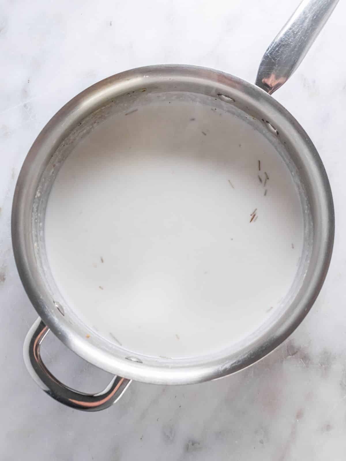 Almond milk, broth, and coconut cream in a skillet to make sauce.