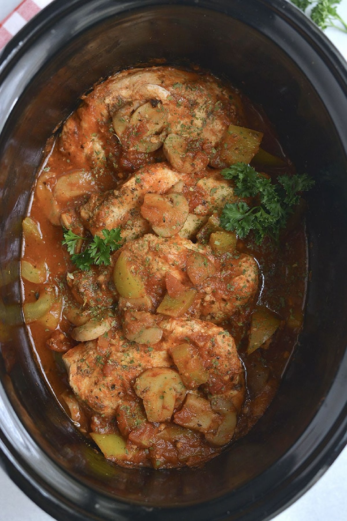 chicken and mushrooms in a slow cooker.