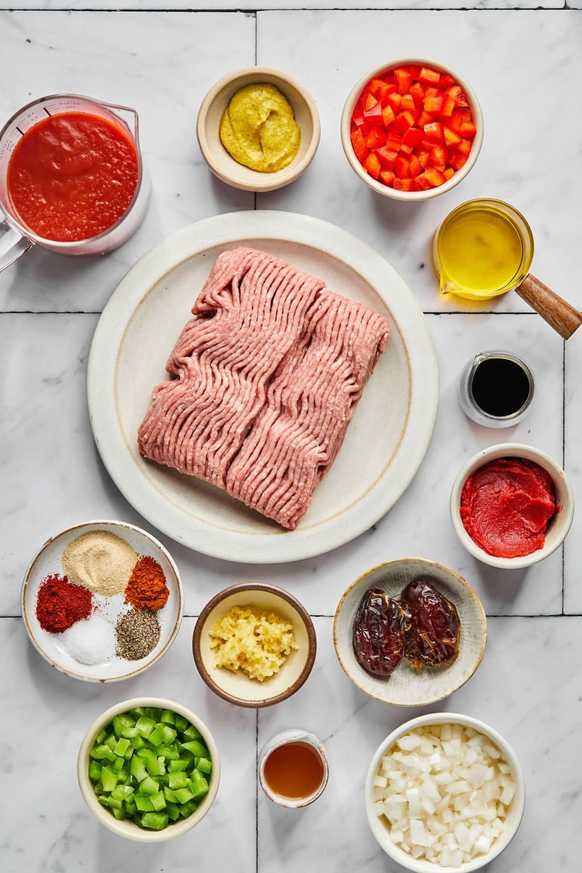 Ingredients to make healthy sloppy joes in the crockpot on the table in small bowls.