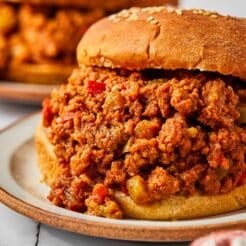 Turkey sloppy joes on buns served on plates on the table.
